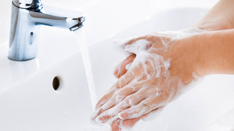 Henkilö pesemässä käsiä