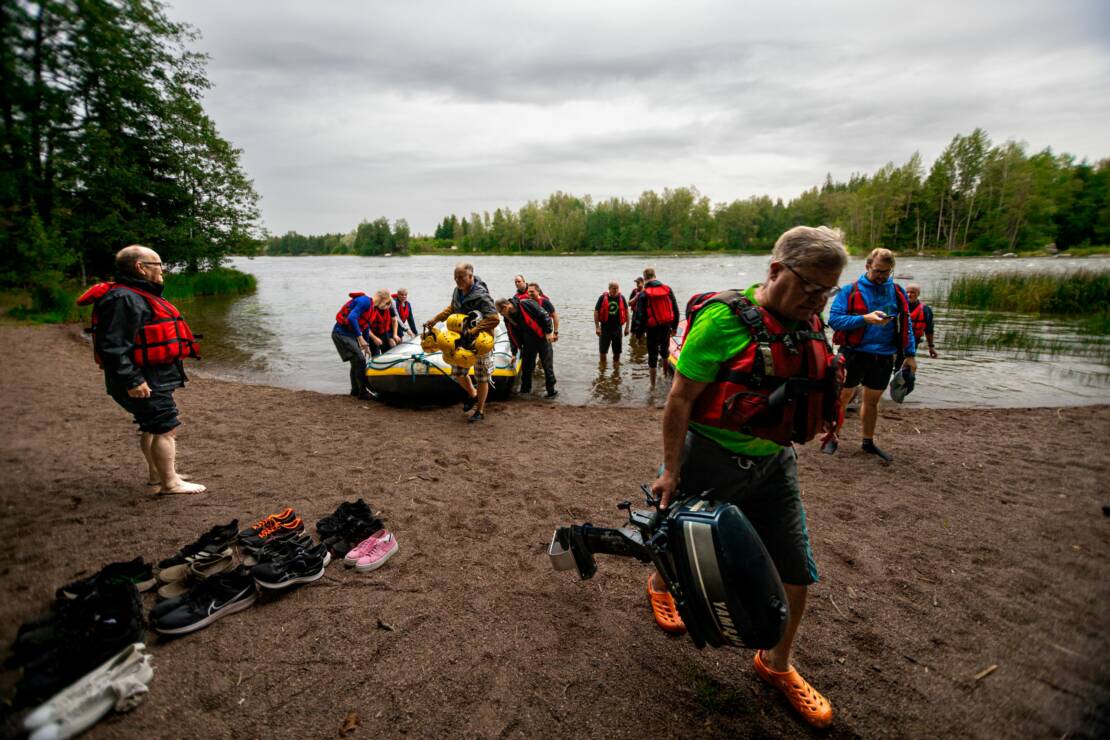 Anjalan sopimuspalokunnan väkeä palaamassa kanooteilta Kymijoen rantaan koskiharjoituksen jälkeen.